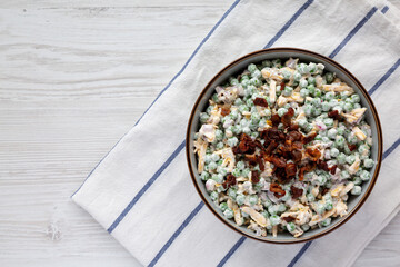 Homemade Creamy Bacon Pea Salad in a Bowl, top view. Flat lay, from above, overhead view. Copy space.