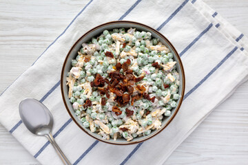 Homemade Creamy Bacon Pea Salad in a Bowl, top view. Flat lay, from above, overhead view.