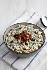 Homemade Creamy Bacon Pea Salad in a Bowl, side view.