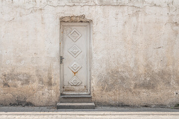 abstract background of an old wall with rusty metal door