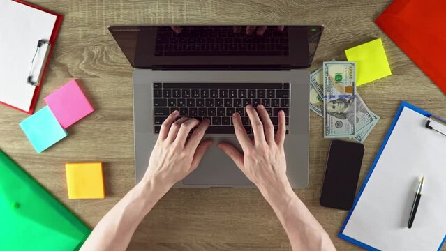 Man is earn money developing the websites using laptop.