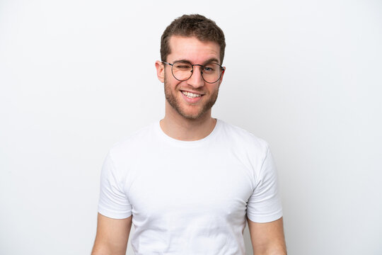 Young caucasian man isolated on white background With glasses and happy expression