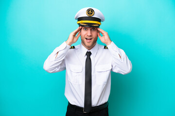 Airplane caucasian pilot isolated on blue background with surprise expression