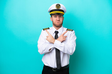 Airplane caucasian pilot isolated on blue background pointing to the laterals having doubts