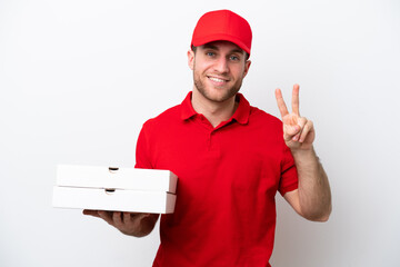 Pizza delivery caucasian man with work uniform picking up pizza boxes isolated on white background smiling and showing victory sign