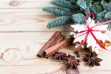 Gingerbread cookies on a wooden background with spices and a Christmas tree branch. Christmas and New Year holidays. Top view. - 521880592