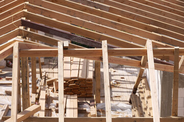 Roofing construction. Wooden roof frame during house construction. Focus on the front planks.