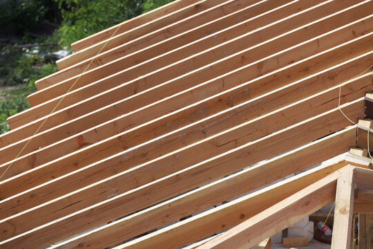 Roof building at new house construction. Brown roof tiles covering estate