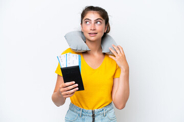 Young caucasian woman with Inflatable travel pillow¬†isolated on white background thinking an idea while looking up