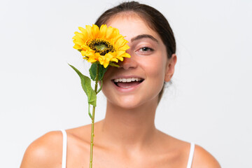 Young Pretty caucasian woman isolated on white background holding a sunflower while smiling. Close up portrait