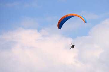 Paragliders flying over mountains in Interlaken, Switzerland. Silhouette of Swiss Alps. Tandem...