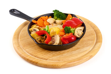 Scrambled eggs with steamed vegetables in a pan, organic food, isolated on white background.