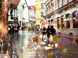Obraz premium Autumn rain and leaves bokeh neon ,pedestrian with umbrellas ,light in City evening blurred street reflection modern buildings urban architecture, cold season 