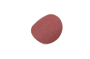 Bended red sandpaper in the shape of a circle.