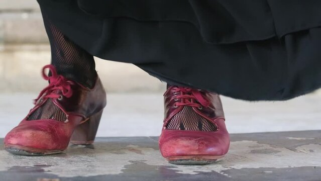 Flamenco dancers legs in red shoes close-up in slow motion, Andalusia, Spain.