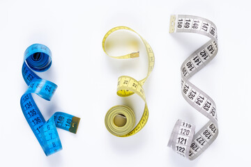 Tailor measuring tape at white background, top view. Tape measure on white