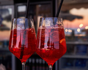 Spritz traditional cocktail with alcohol at a beach bar. European summer drink. Italian drink. Lifestyle concept