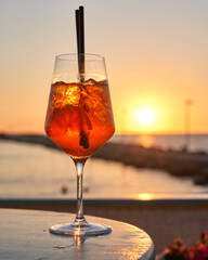 Spritz traditional cocktail with alcohol at a beach bar. European summer drink. Italian drink. Lifestyle concept