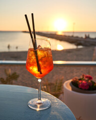 Spritz traditional cocktail with alcohol at a beach bar. European summer drink. Italian drink. Lifestyle concept