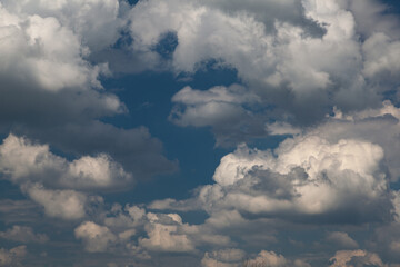 Fototapeta na wymiar Puffy Clouds in a Blue Sky