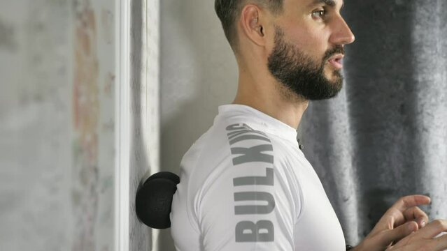 Back massager. exercise near the wall for the prevention and relaxation of spasmodic muscles when working at a computer.