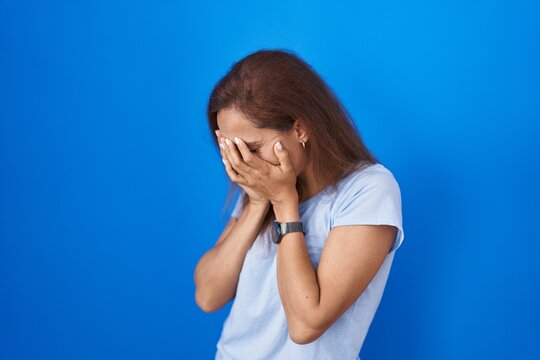 Young Woman Standing Blue Background Sad Expression Covering Face Hands ...
