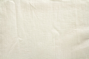 wrinkled natural linen beige fabric, top view, textile background