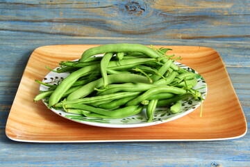 garden fresh vegetable green beans in plate closeup top view