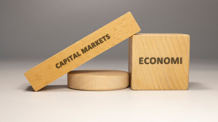 Capital markets written on wooden surface. economy and business.