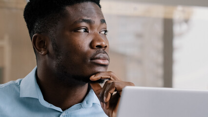 Thoughtful african american businessman writer dreamer genius man biracial guy holds hand on chin...