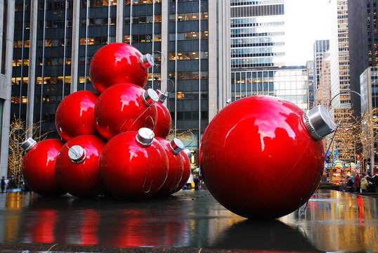 Large Christmas balls sit in a fountain in a plaza during the holiday season in New York City