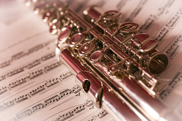 close up of the flute, musical instrument on the music sheet, artistic