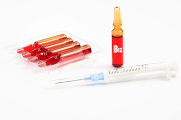 Injection of vitamins B 12. Ampoules with red liquid. Copy space