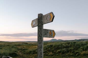 signpost on the coast at sunset