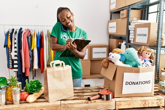 Young african american volunteer woman smiling happy working at charity center.