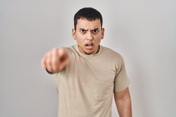 Young arab man wearing casual t shirt pointing displeased and frustrated to the camera, angry and furious with you