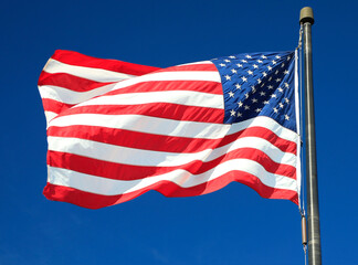 United States of America waving flag on the blue-sky background