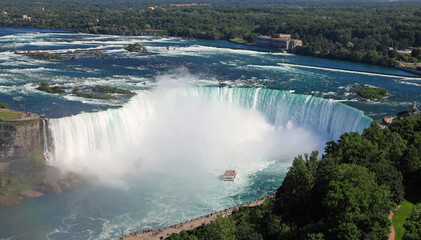 Aerial view of Horseshoe Falls including Hornblower Boat sailing on Niagara River, Canada and USA natural border