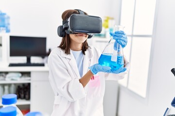 Young hispanic girl wearing virtual reality glasses at laboratory