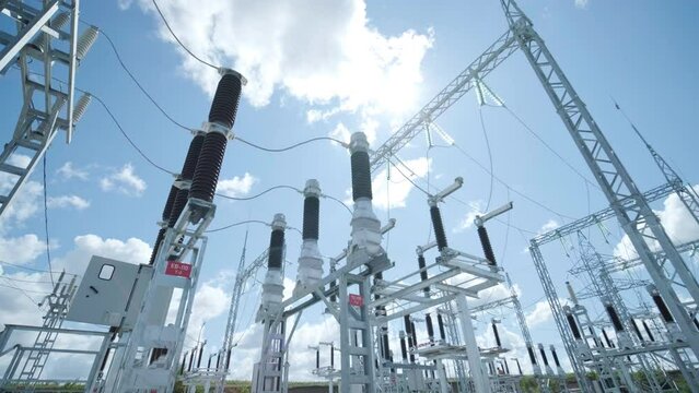 High voltage transformer against the blue sky. Electric current redistribution substation