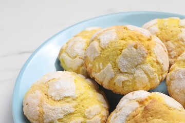 Plate with delicious lemon cookies on white table, closeup