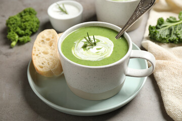 Tasty kale soup served on grey table, closeup