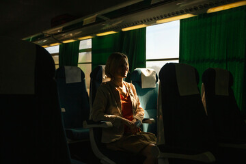 A woman sit of a moving intercity bus.
