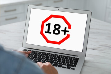 Woman using laptop with age limit sign 18+ years indoors, closeup - obrazy, fototapety, plakaty