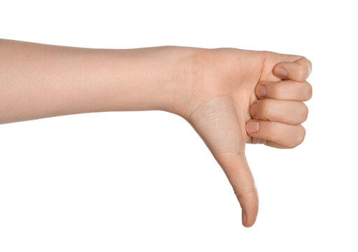 Woman showing thumb down gesture on white background, closeup of hand