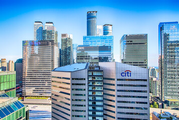 Fototapeta premium TORONTO, CANADA - JULY 18, 2022: Facades of the skyscrapers of Delta, PWC, CITI Bank, Telus and MarshMcLennan and the nearby high - rise buildings Downtown Toronto.