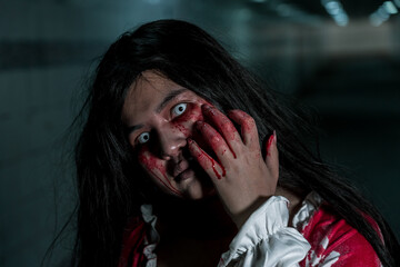 Girl ghost woman death with blood the horror is screaming darkness and nightmare dark background,...