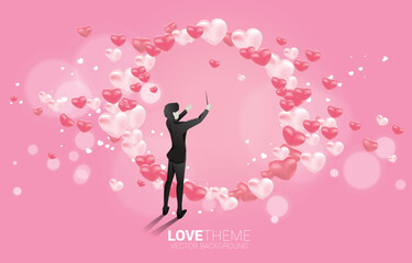 Vector silhouette of conductor standing with heart balloon flying . Concept background for love song and concert theme.