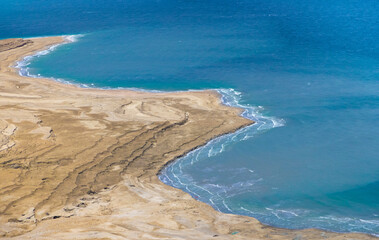 Israel views of Dead Sea shore near Masada Fortress and Mosada National Park in Judaean Desert.