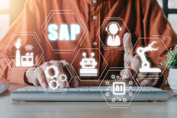 SAP - Business process automation software and management software (SAP), Person hand typing on keyboard with ERP enterprise resources planning system concept on virtual screen.